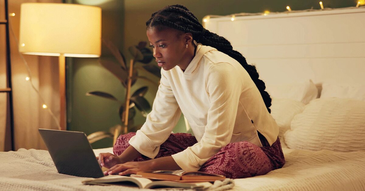 Woman researching abortion and adoption pregnancy options on her laptop at home.